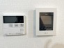 清潔感ある壁に、機能的なインターホンと給湯器リモコンが設置された、暮らしを支える空間。
