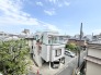 穏やかな空の下、周辺の街並みと調和しながら落ち着いた佇まいを見せる住まいです。