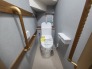 ウォシュレット機能付きのトイレ。収納もあり実用性も兼ね備えた造り。
