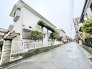 緑豊かな植栽と白いフェンスが、穏やかな日々を予感させる邸宅。