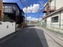 青空が広がり心地よい風が吹き抜ける閑静な住宅街の開放的な前面道路