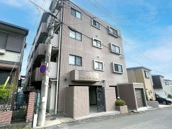 落ち着いた色調のタイル貼りの外観が、周囲の街並みに自然と馴染む佇まいを見せています
