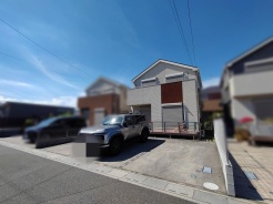青空を背景に佇む、洗練されたフォルムが印象的な穏やかな街並みに馴染む住まいです。